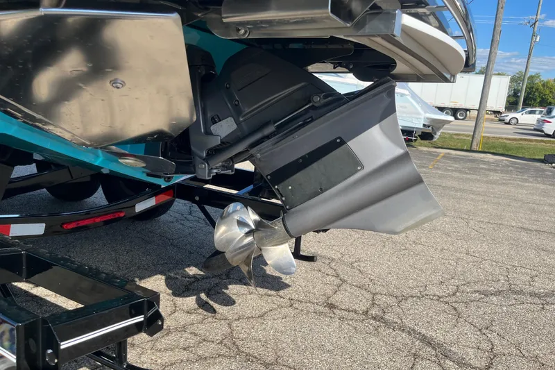 Slide: The Image of 2024 Regal LS9 Surf boat propeller and stern detail in parking lot. - 23
