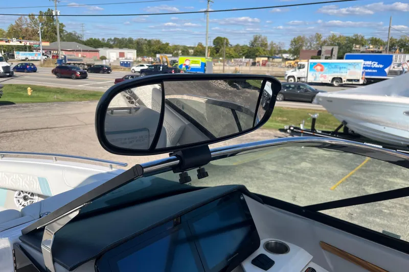 Slide: The Image of 2024 Regal LS9 Surf boat dashboard with rearview mirror and digital display. - 25