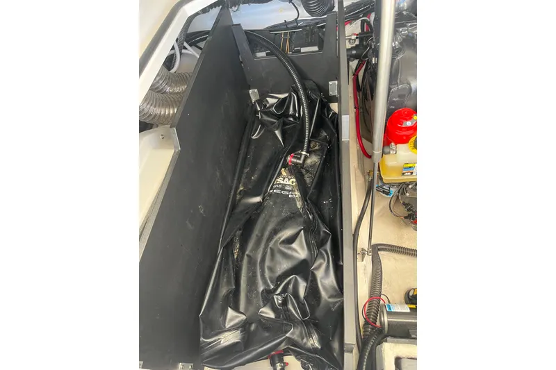 Slide: The Image of 2024 Regal LS9 Surf boat interior showing ballast system and engine components. - 26