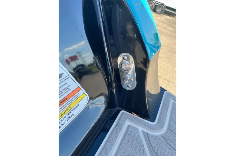 Slide: The Image of 2024 Regal LS9 Surf boat detail with control buttons and caution label. - 27