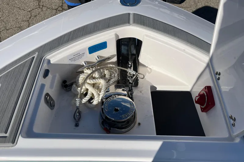 Slide: The Image of 2024 Regal LS9 Surf boat anchor compartment with rope and winch. - 4