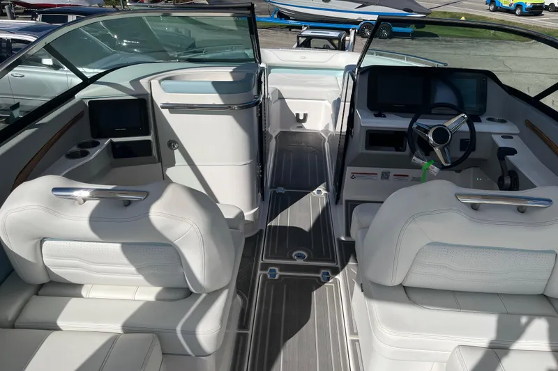 Slide: The Image of 2024 Regal LS9 Surf boat interior with white seating and modern dashboard design. - 6