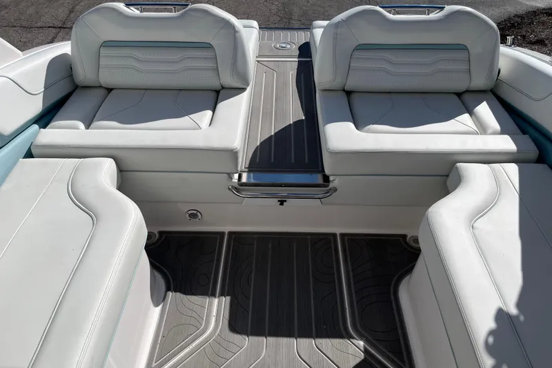 Slide: The Image of 2024 Regal LS9 Surf boat interior with luxurious white seating and sleek flooring. - 7
