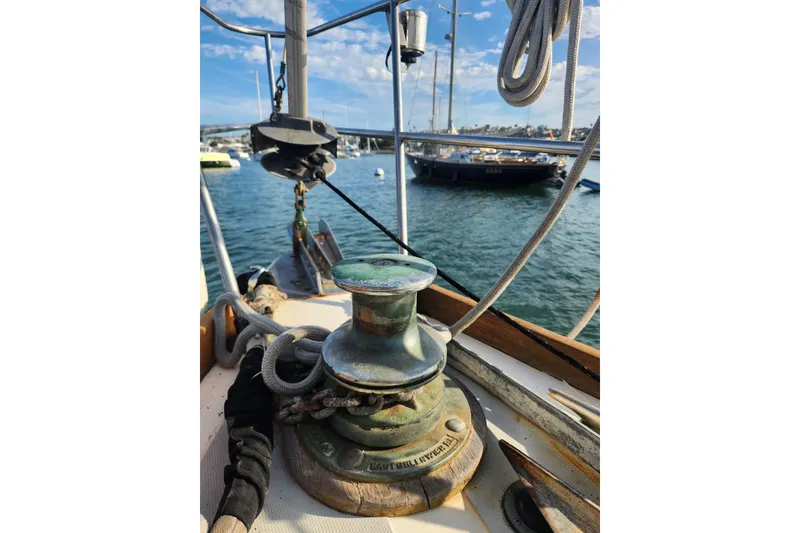 Slide: The Image of 1981 Guflstar Center Cockpit sailboat deck with winch and ropes, docked in marina. - 10