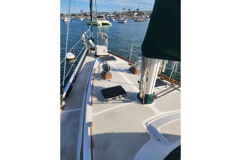 Slide: The Image of 1981 Guflstar Center Cockpit sailboat deck with marina view in the background. - 12