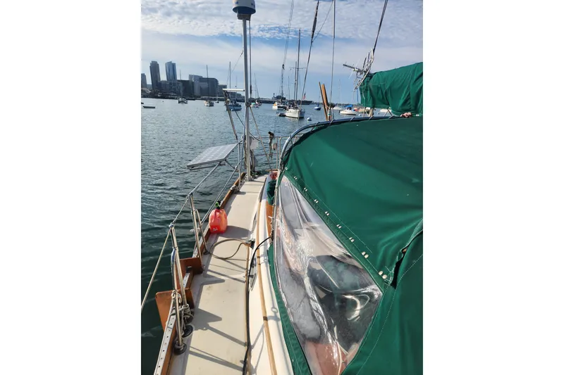 Slide: The Image of 1981 Guflstar Center Cockpit sailboat docked in a marina with city skyline. - 14
