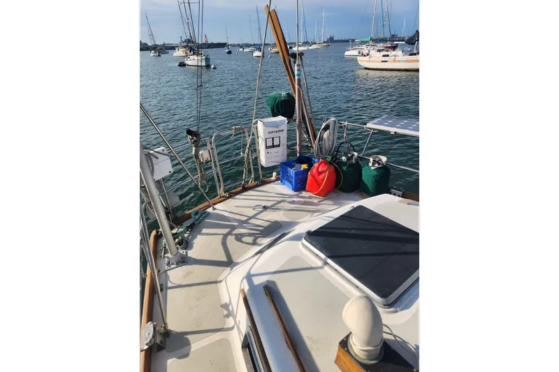 Slide: The Image of 1981 Guflstar Center Cockpit sailboat deck with equipment, moored in a marina. - 15