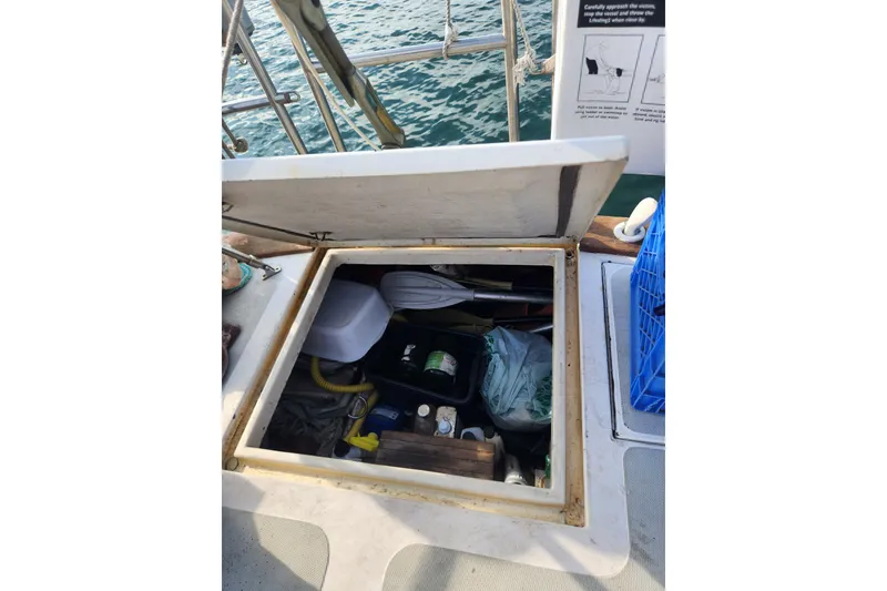 Slide: The Image of Open storage compartment on 1981 Guflstar Center Cockpit boat, filled with various items. - 17