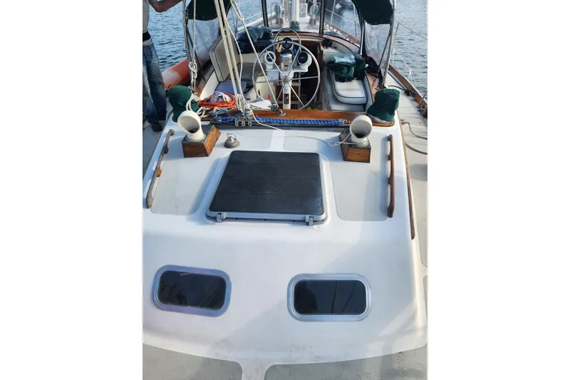 Slide: The Image of 1981 Guflstar Center Cockpit sailboat deck with steering wheel and nautical equipment. - 19