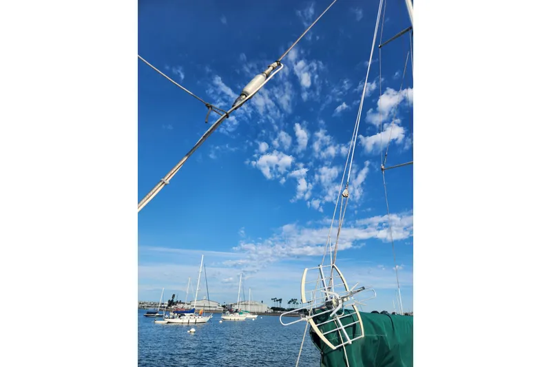 Slide: The Image of Sailboat rigging against a blue sky, featuring a 1981 Guflstar Center Cockpit. - 23
