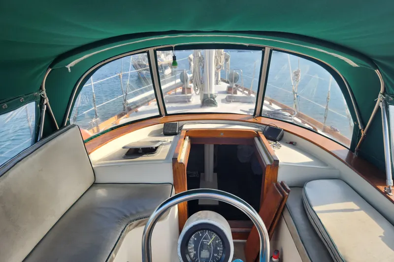 Slide: The Image of 1981 Guflstar Center Cockpit sailboat interior with green canopy and steering wheel. - 28