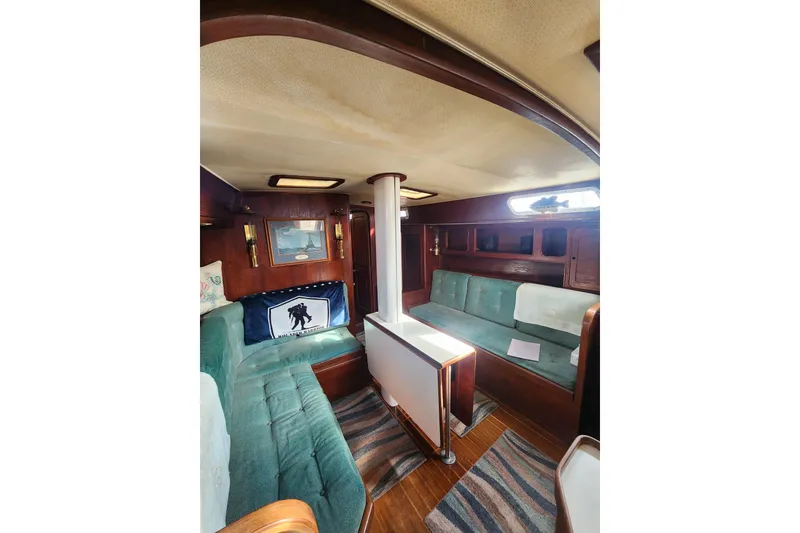 Slide: The Image of Interior of 1981 Guflstar Center Cockpit sailboat with teal seating and wooden accents. - 31