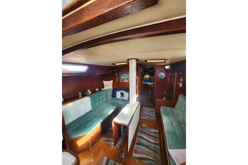Slide: The Image of Interior of 1981 Guflstar Center Cockpit sailboat with cozy seating and wooden accents. - 32