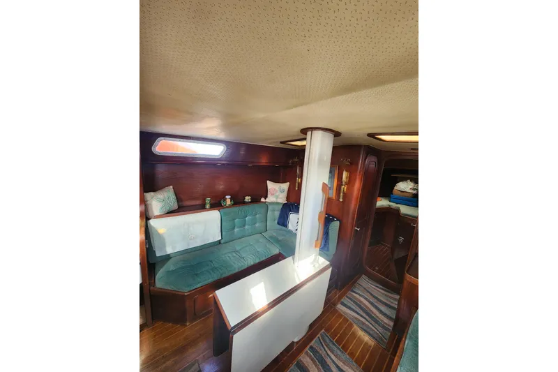 Slide: The Image of 1981 Guflstar Center Cockpit interior with teal seating and wooden accents. - 33