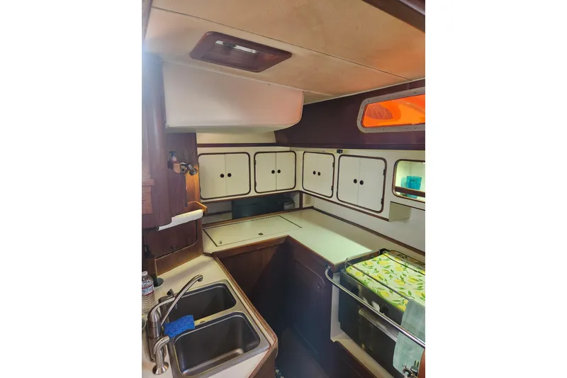 Slide: The Image of 1981 Guflstar Center Cockpit interior with kitchen sink, cabinets, and stove. - 34