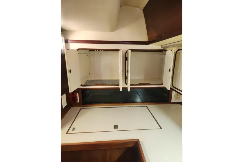 Slide: The Image of 1981 Guflstar Center Cockpit interior with open storage cabinets and wooden accents. - 36