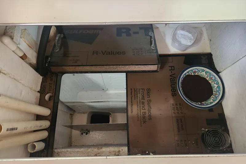 Slide: The Image of Interior view of a 1981 Guflstar Center Cockpit with storage and insulation materials. - 37