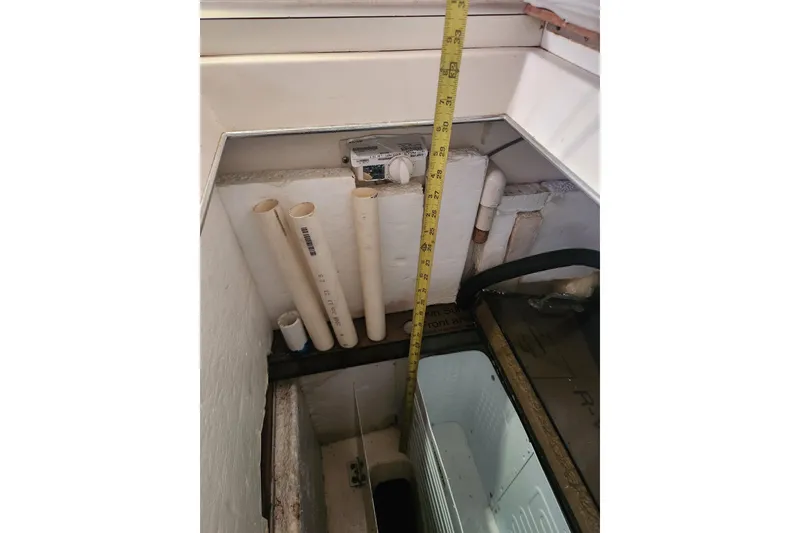 Slide: The Image of Interior view of 1981 Guflstar Center Cockpit showing pipes and measuring tape. - 38