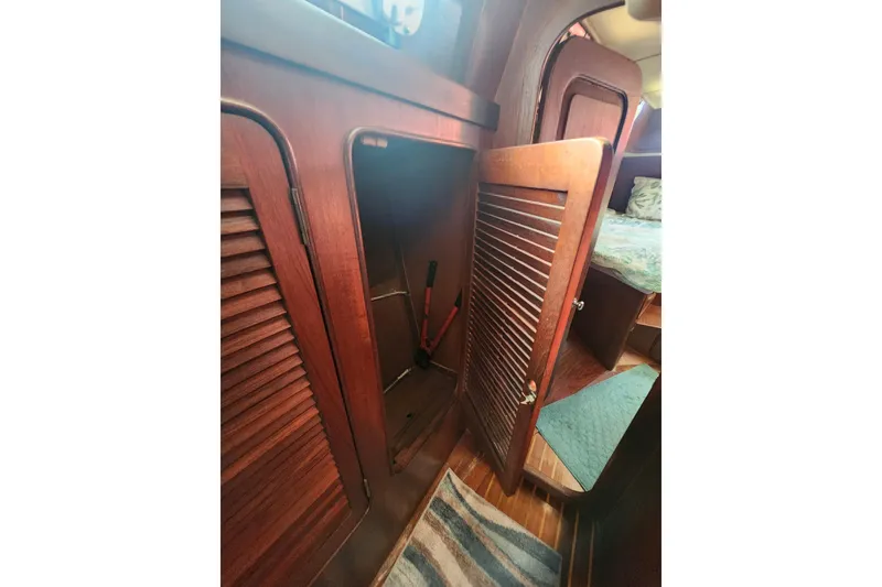 Slide: The Image of 1981 Guflstar Center Cockpit interior with open wooden cabinet and cozy cabin view. - 42