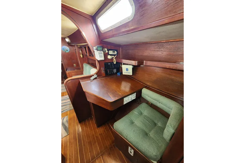 Slide: The Image of 1981 Guflstar Center Cockpit interior with wooden desk and green cushioned chair. - 46