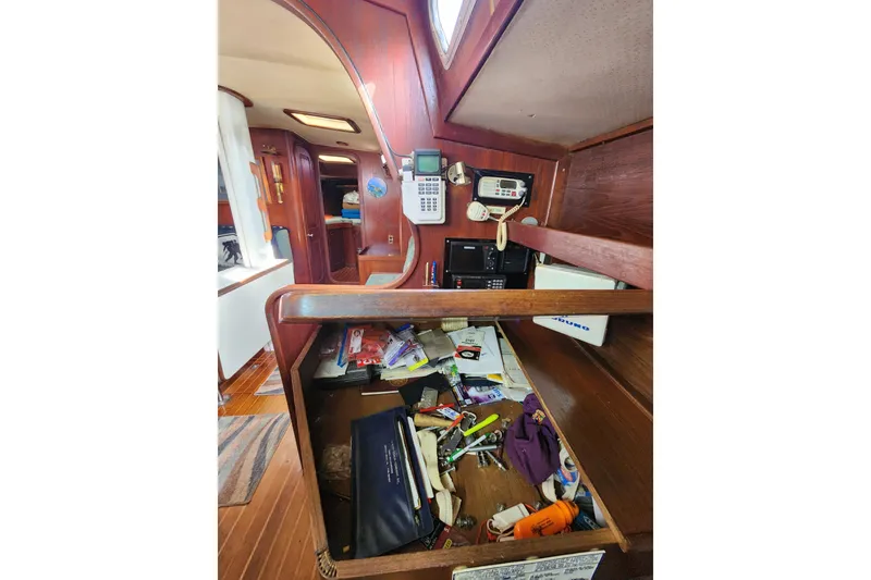 Slide: The Image of Interior of 1981 Guflstar Center Cockpit with navigation equipment and cluttered storage. - 47