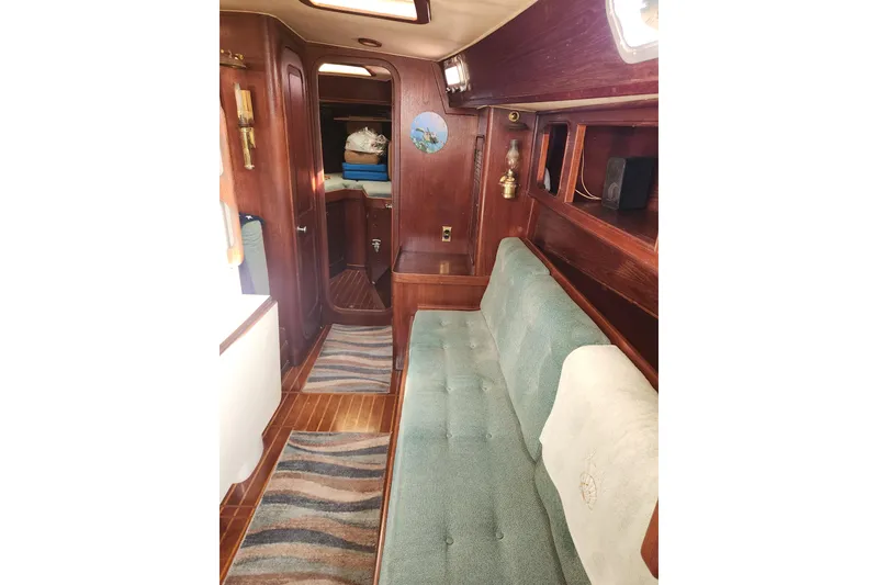 Slide: The Image of 1981 Guflstar Center Cockpit interior with wooden finish and green seating. - 48