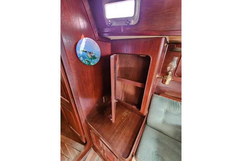 Slide: The Image of 1981 Guflstar Center Cockpit interior with wooden cabinetry and decorative wall clock. - 49