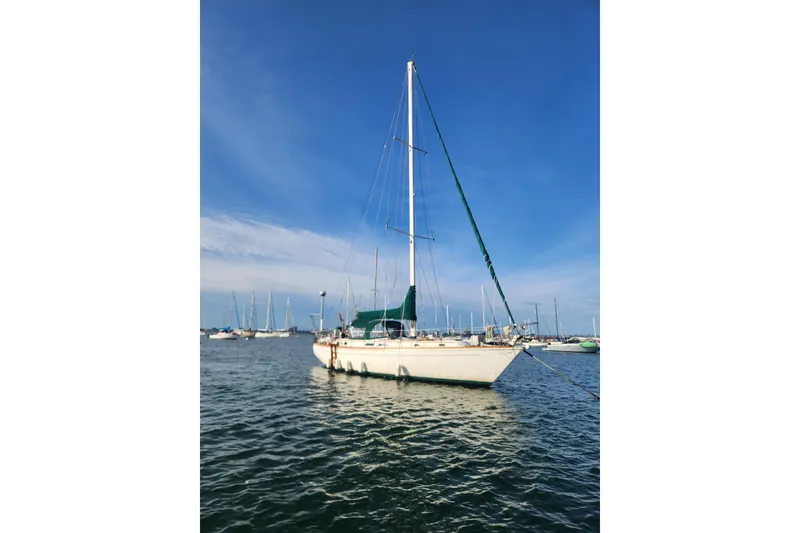 Slide: The Image of 1981 Guflstar Center Cockpit sailboat anchored on calm water under clear blue sky. - 5