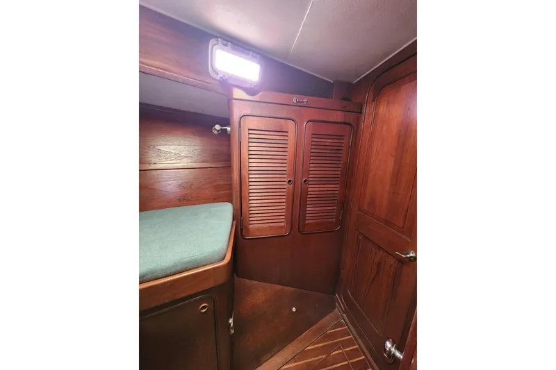 Slide: The Image of 1981 Guflstar Center Cockpit interior with wooden cabinetry and cozy sleeping area. - 51