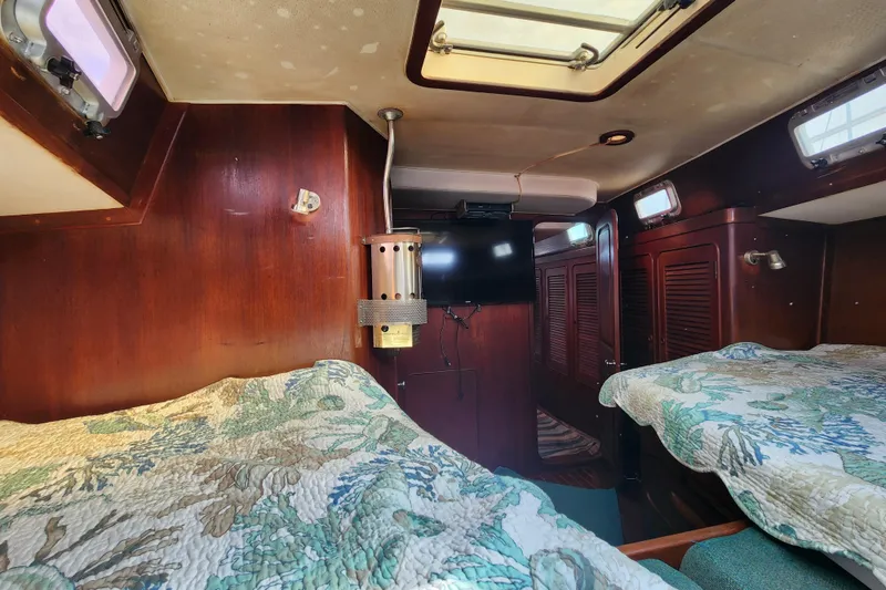 Slide: The Image of 1981 Guflstar Center Cockpit interior with wood paneling and twin beds. - 54