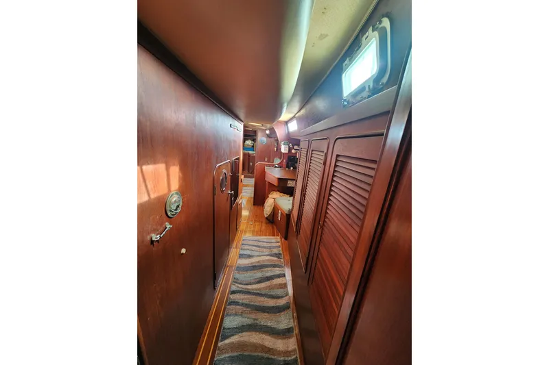 Slide: The Image of 1981 Guflstar Center Cockpit interior with wooden paneling and nautical decor. - 56
