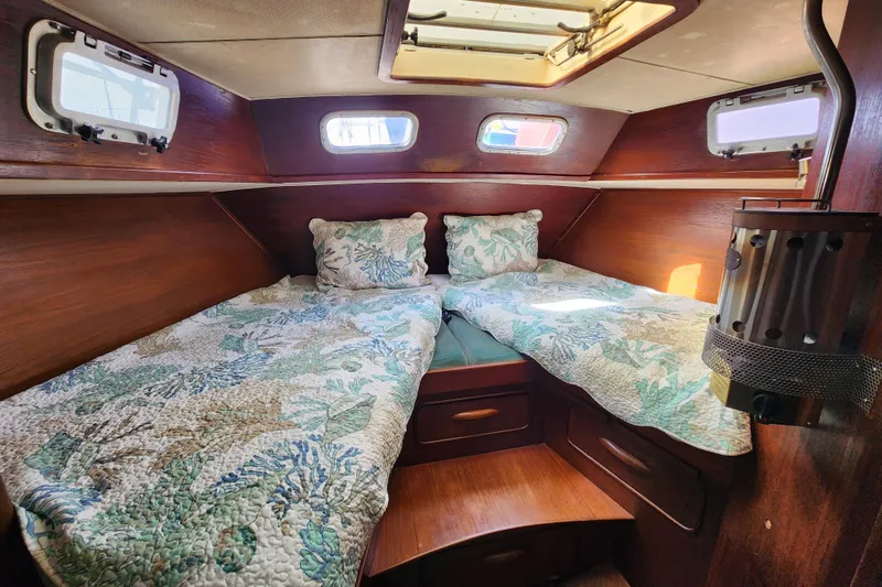 Slide: The Image of Cozy cabin interior of 1981 Guflstar Center Cockpit with twin beds and floral bedding. - 60