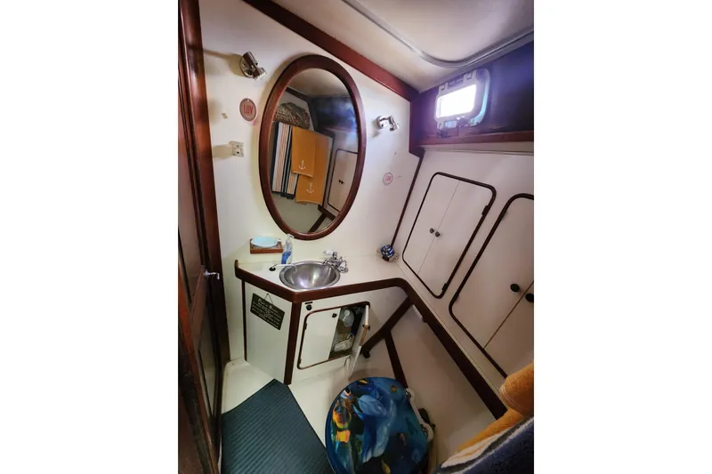 Slide: The Image of 1981 Guflstar Center Cockpit bathroom with sink, mirror, and storage cabinets. - 61