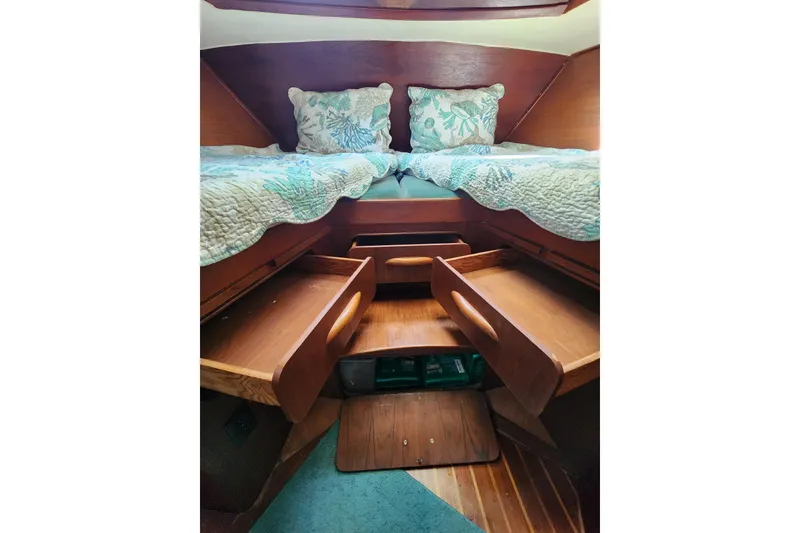 Slide: The Image of 1981 Guflstar Center Cockpit interior with wooden storage and cozy bedding. - 66