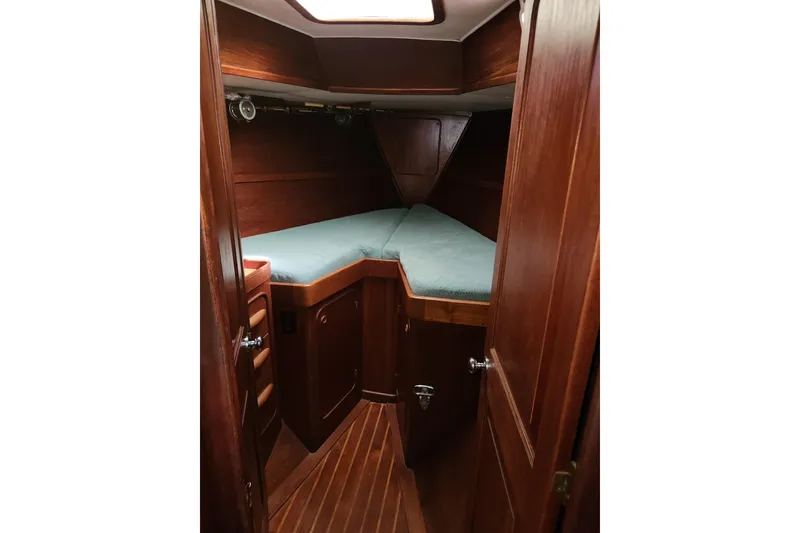 Slide: The Image of 1981 Guflstar Center Cockpit cabin interior with wooden finish and cozy sleeping area. - 68