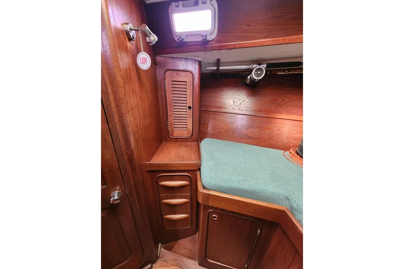 Slide: The Image of 1981 Guflstar Center Cockpit interior with wooden cabinetry and green cushioned seating. - 69