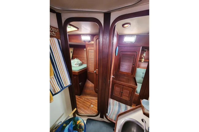 Slide: The Image of Interior of 1981 Guflstar Center Cockpit sailboat with wooden cabinetry and cozy seating. - 70