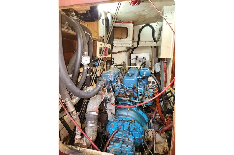Slide: The Image of Engine room of 1981 Guflstar Center Cockpit sailboat with visible blue engine components. - 74