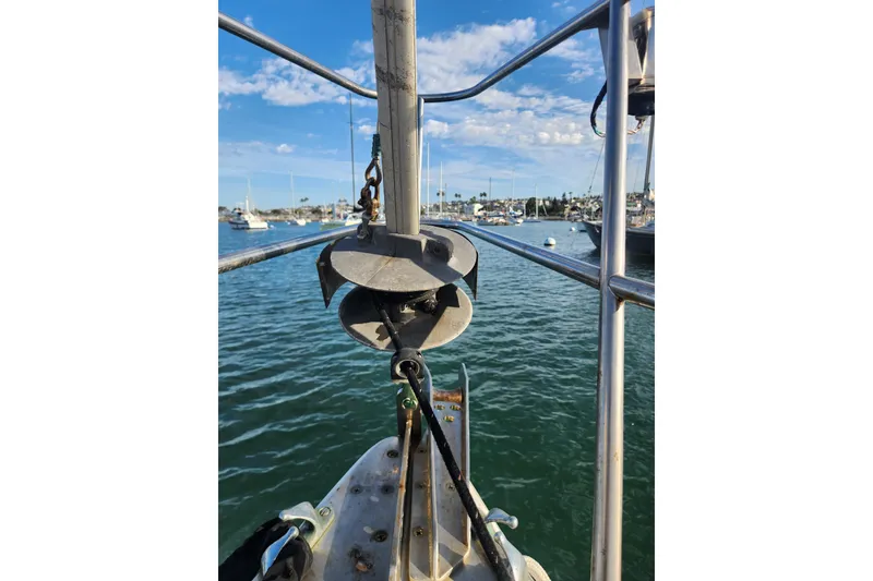 Slide: The Image of 1981 Guflstar Center Cockpit sailboat with anchor, docked in a marina under blue skies. - 9