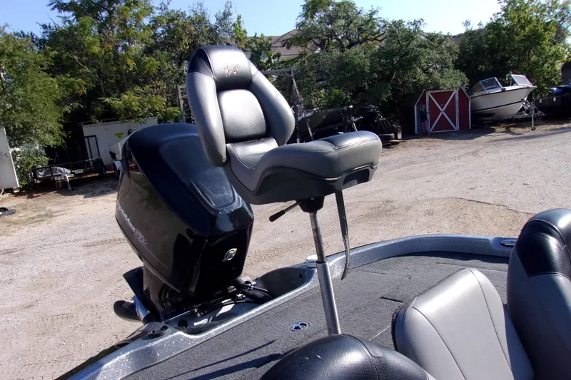 Slide: The Image of 2009 Ranger 188 VX boat with elevated seat and motor, parked outdoors. - 11