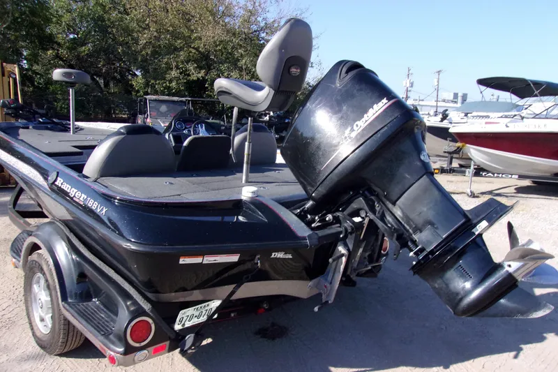 Slide: The Image of 2009 Ranger 188 VX boat with outboard motor, parked on a trailer. - 4