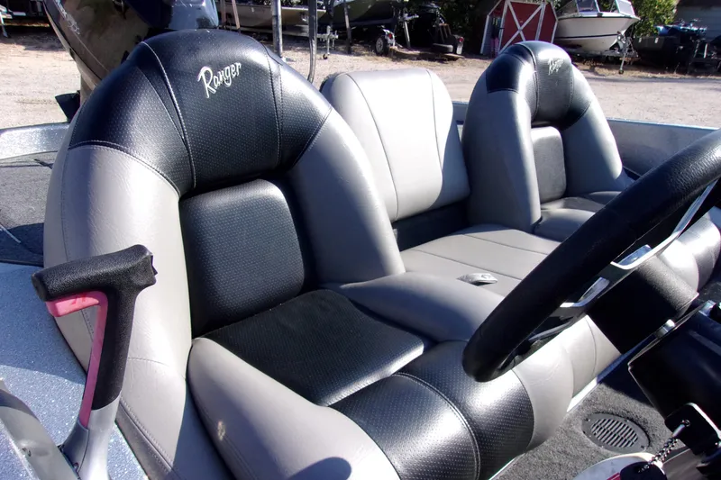 Slide: The Image of 2009 Ranger 188 VX boat interior with black and gray seating and steering wheel. - 8