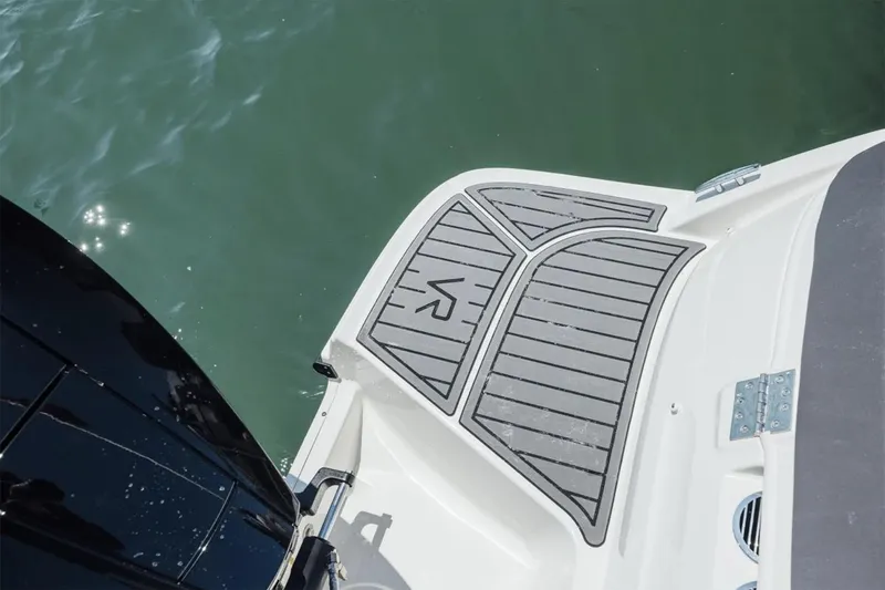 Slide: The Image of 2026 Bayliner VR6 Bowrider OB on trailer, parked on grass under cloudy sky. - 11