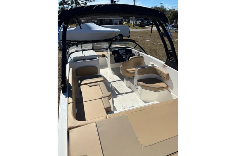 Slide: The Image of 2026 Bayliner VR6 Bowrider OB on trailer, parked outdoors under cloudy sky. - 16