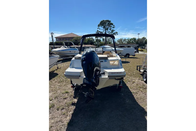 Slide: The Image of 2026 Bayliner VR6 Bowrider OB with outboard motor, parked on grass. - 18
