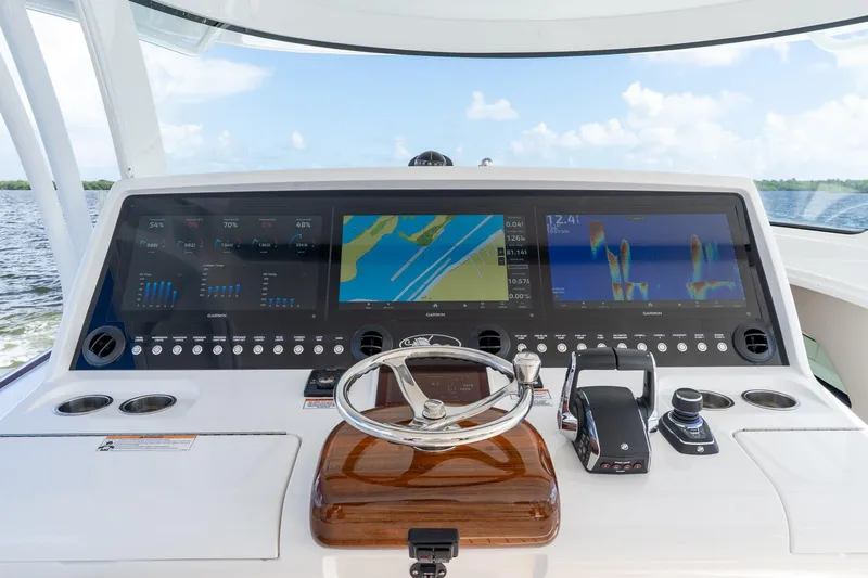 Slide: The Image of 2025 Valhalla Boatworks V-55 helm with advanced navigation displays and controls. - 12