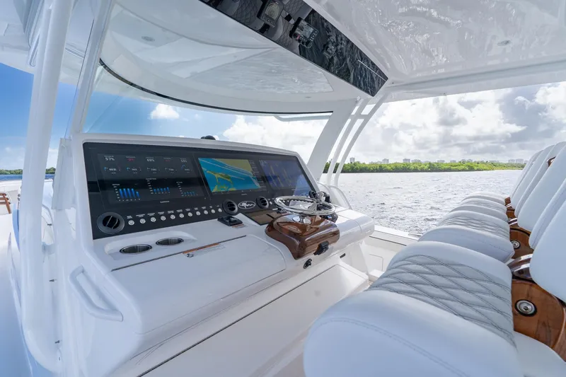 Slide: The Image of 2025 Valhalla Boatworks V-55 helm with advanced navigation system and luxurious seating. - 14