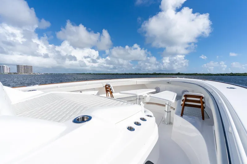 Slide: The Image of 2025 Valhalla Boatworks V-55 on water, featuring spacious deck and seating under blue sky. - 22