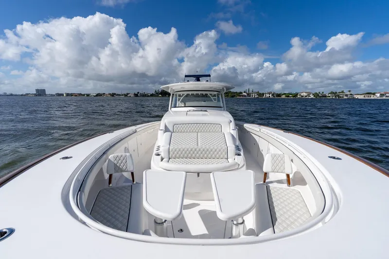 Slide: The Image of 2025 Valhalla Boatworks V-55 luxury yacht on open water under blue sky. - 24