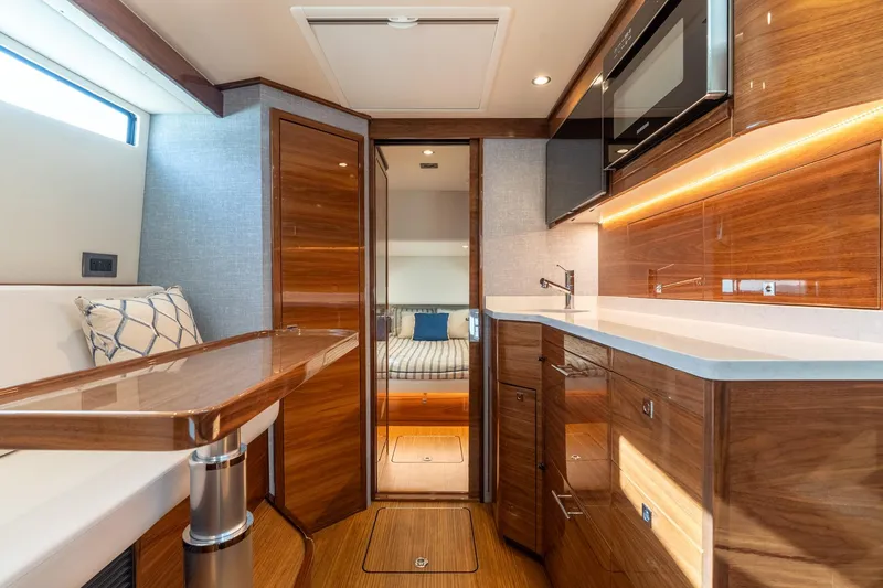 Slide: The Image of Luxurious interior of 2025 Valhalla Boatworks V-55 with modern kitchen and seating area. - 26